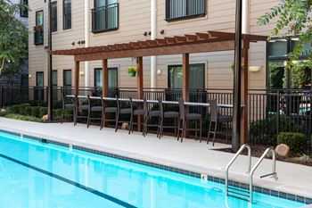 A pool with a building in the background.